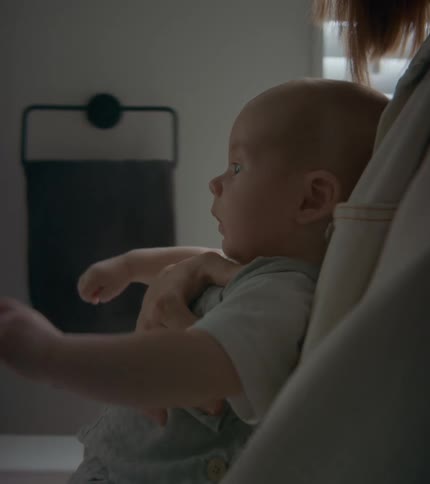 A mother holding a young baby