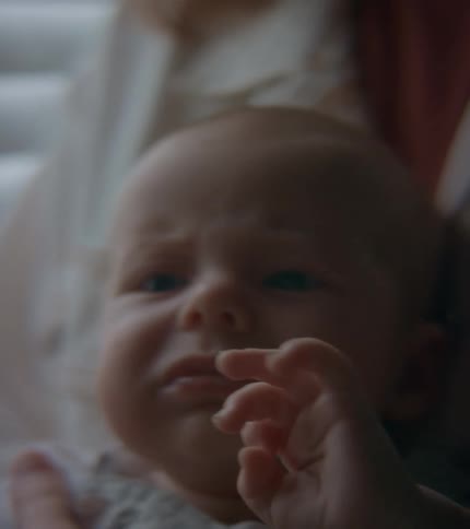 Mother with white shirt holds crying baby