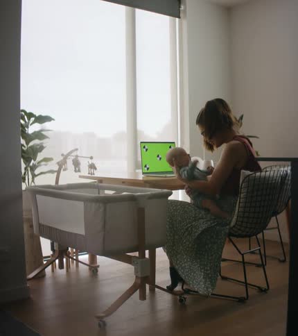 A mother holding her daughter in a room