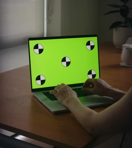 A person using a laptop in a room