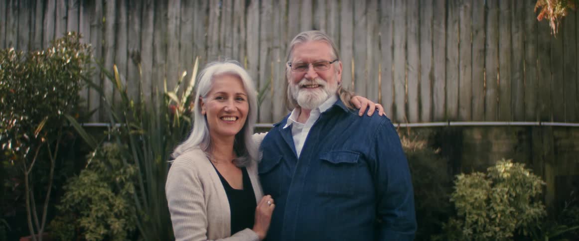 Man and woman posing for a camera
