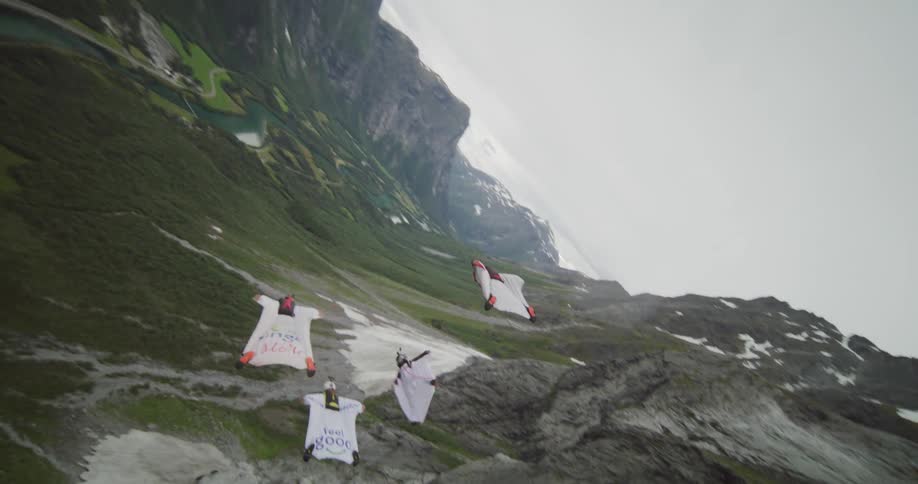 A group of people gliding down a canyon in squirrel suits