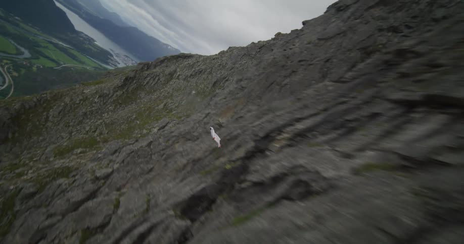 Man gliding near a mountain