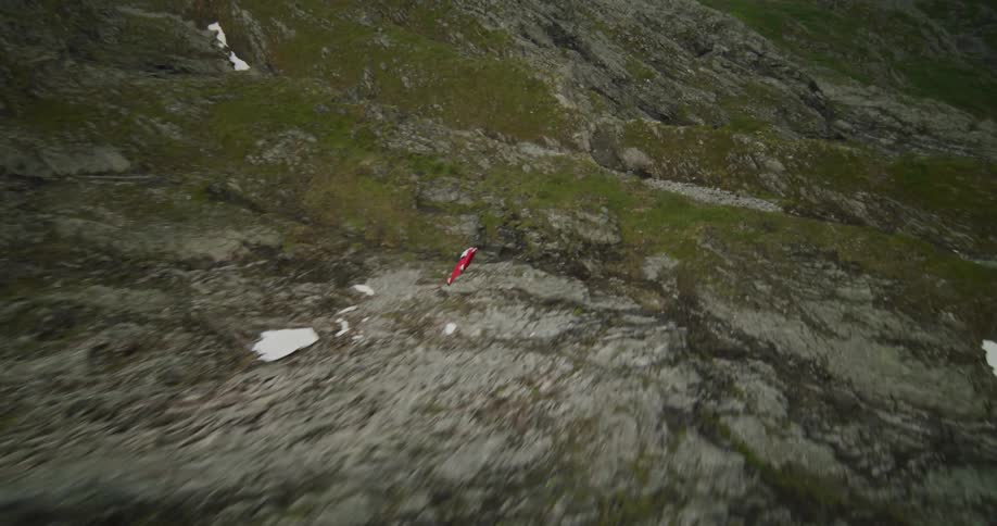 A man in a squirrel suit jumps from a mountain