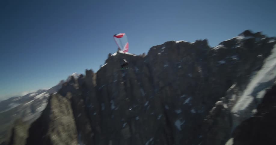 A person gliding down off of a mountain