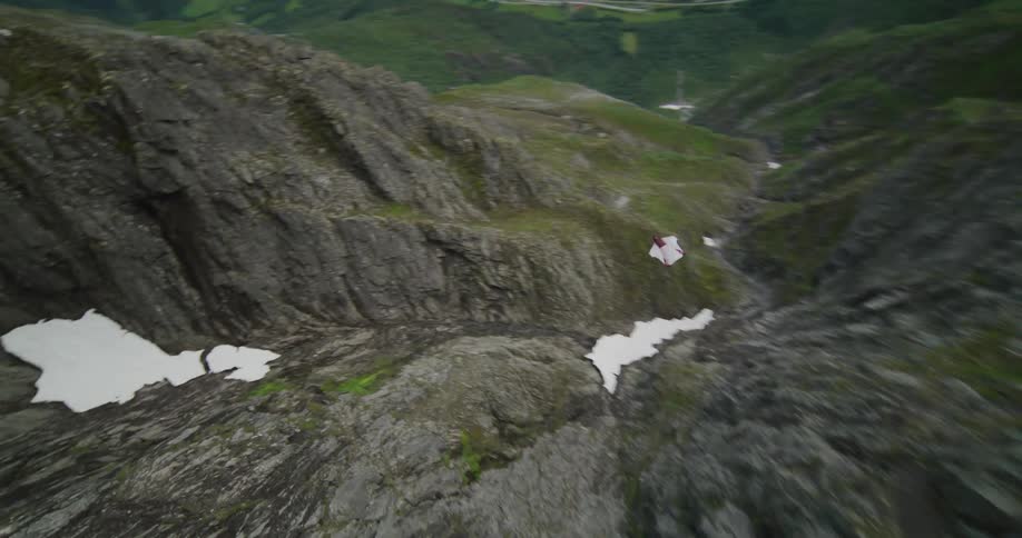 A base jumper soars through the air