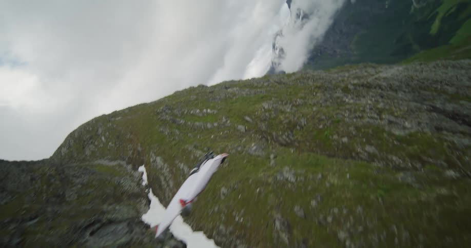 A person is gliding off of a mountain landscape