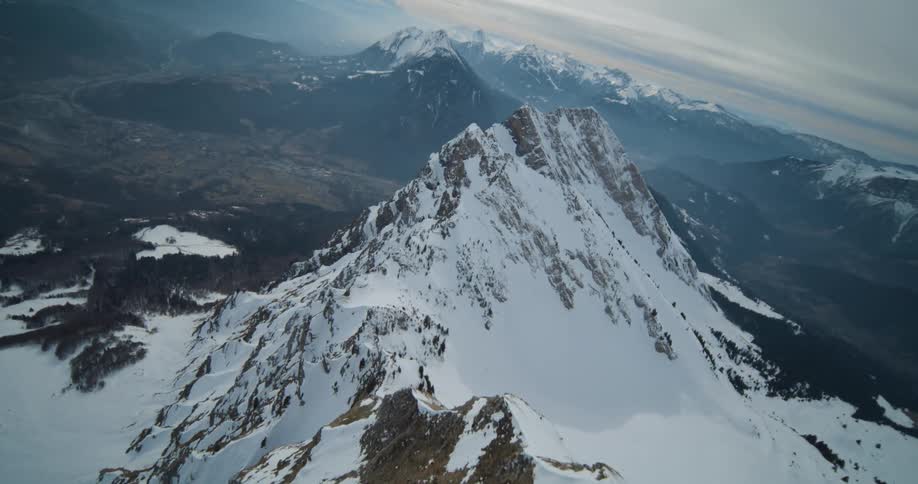 An aerial view of a snow covered mountain range