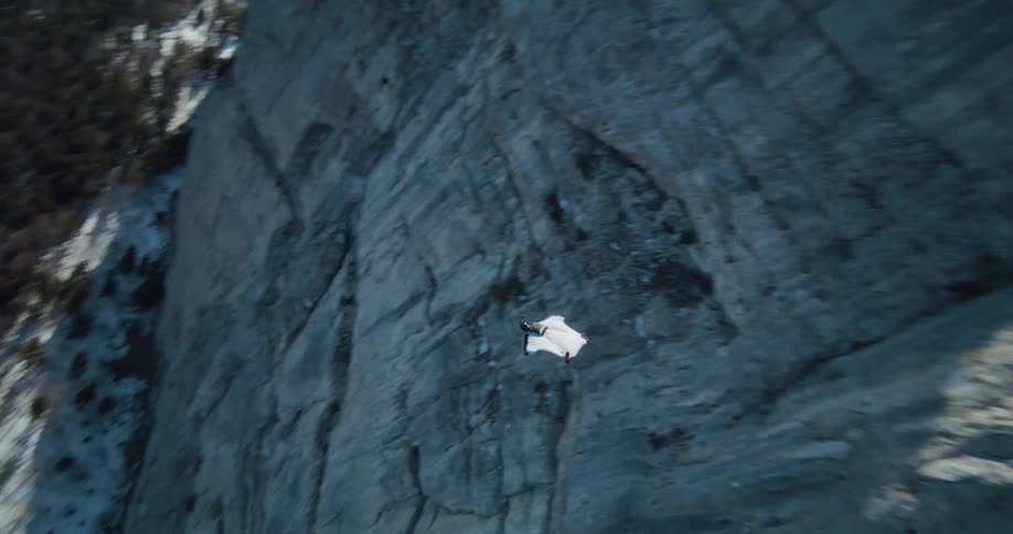 The view is of someone jumping of a cliff in the day time