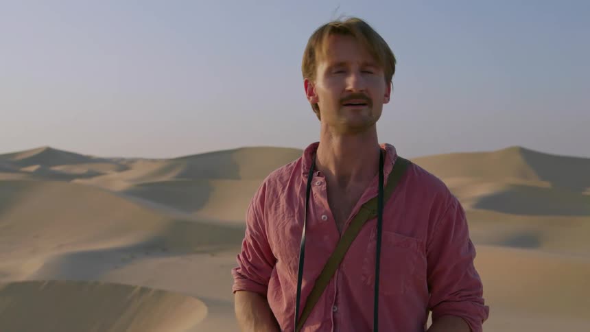 A photographer working in a desert