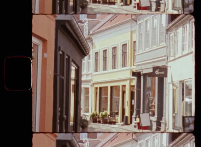 Ws camera panning up on cobblestone alleyway of european city with shops and restaurants