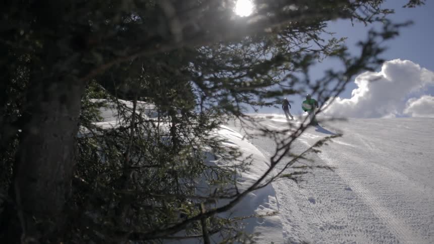 People ski down a steep slope