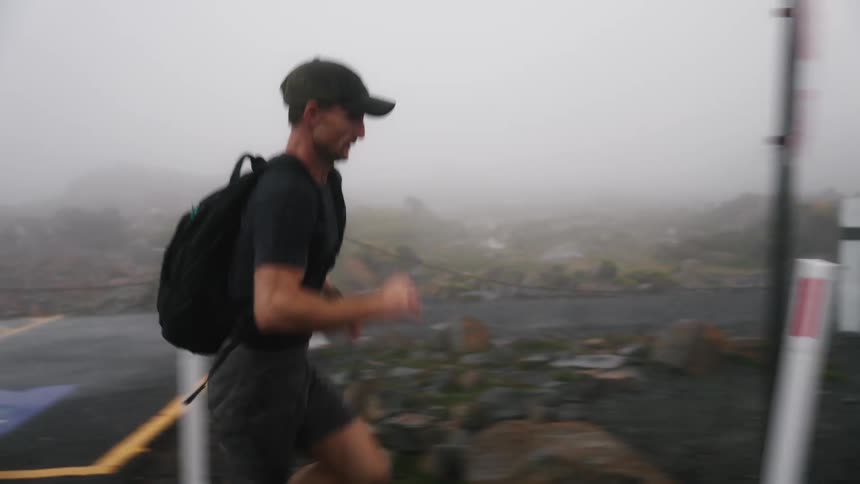 A man exercising runs down a street