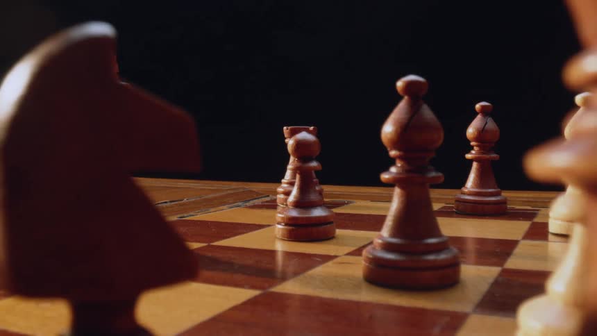 Chess board someone moving a bishop to take a bishop