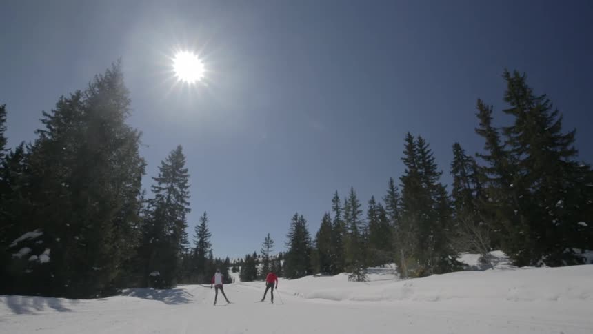 People ski across the snow