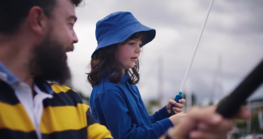 A father and daughter are fishing