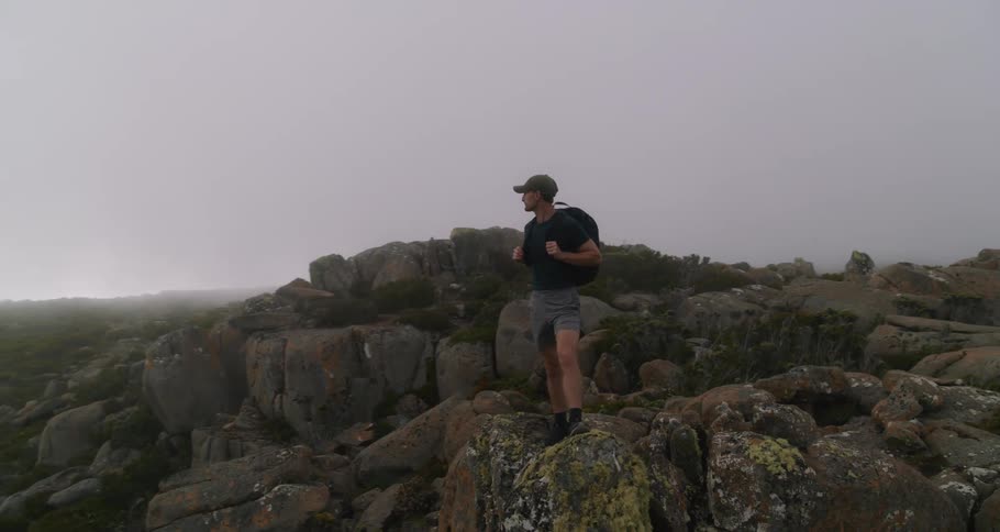 A man is hiking by himself in a mountainous area