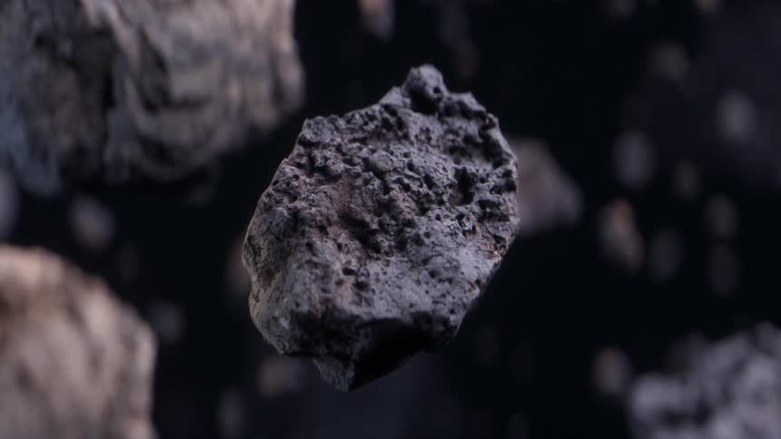 A rock spins and reveals itself as the camera zooms all the way in to its surface