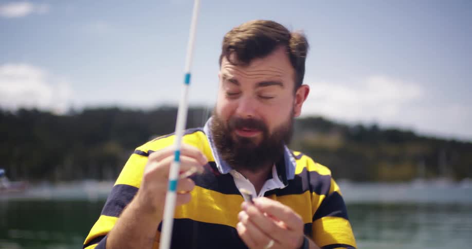 A father and daughter talk while putting bait on a fishing pole