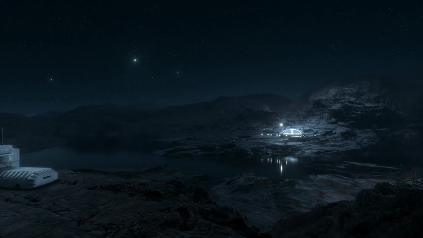 Space colony sits on rocky terrain near water under a night sky