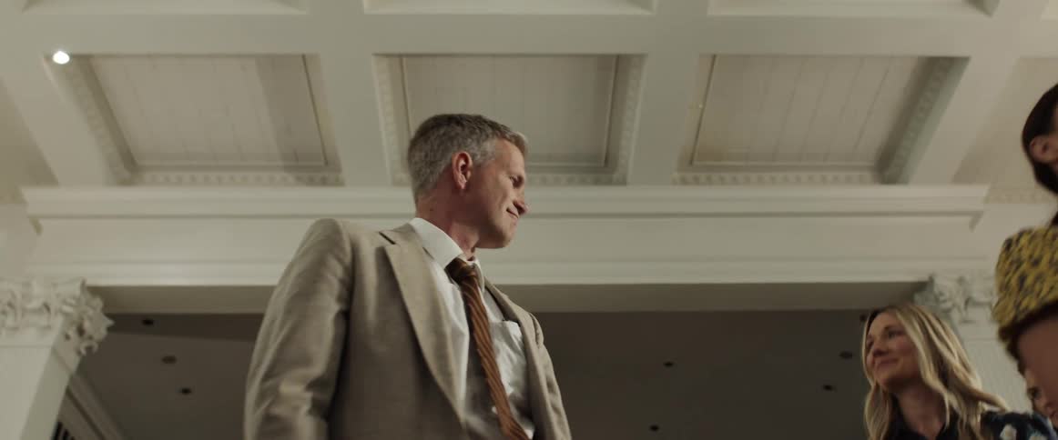 Preacher holds bible and shakes hands with departing congregation