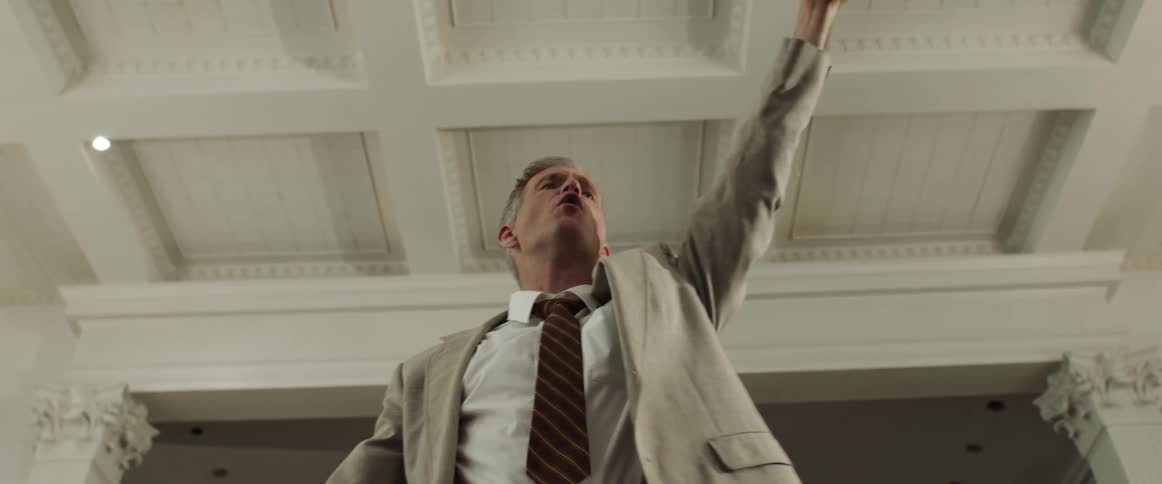 Preacher gestures and shouts while holding bible and giving sermon in church