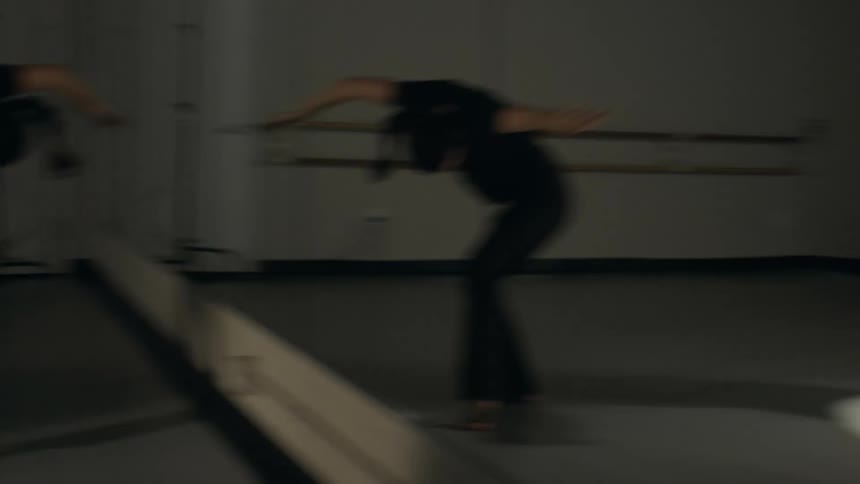 Three women are standing in a room practicing their dance as they bend and stretch their arms out as they move