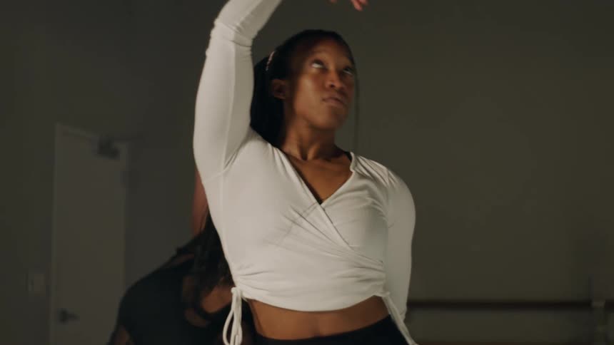 Two women are dancing in the room