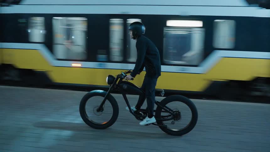 Man with black helmet shirt pants and white sneakers rides wicked thumb electrocycles