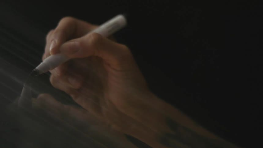 A person is using a marker