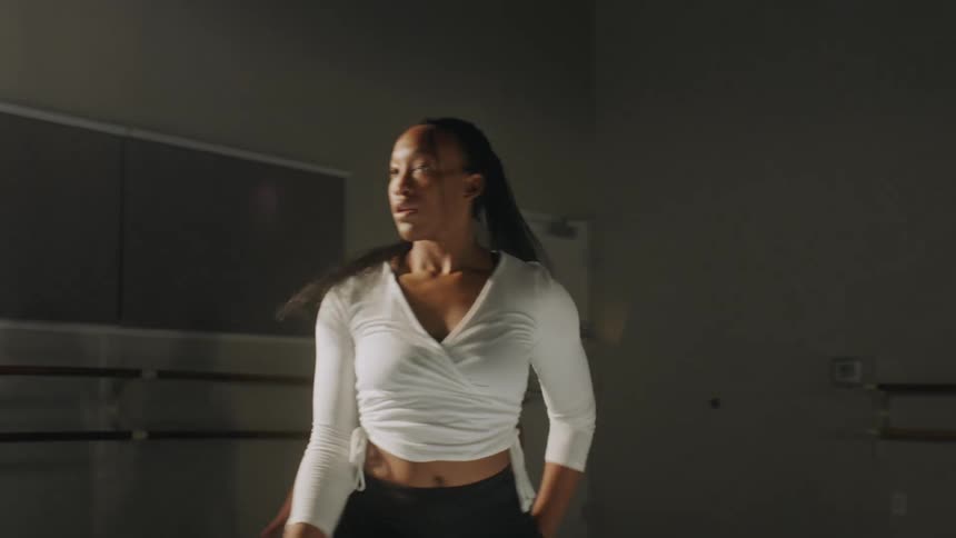 Three women dancing in unison and moving their arms and hands around
