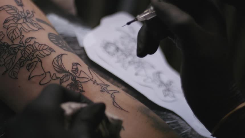 A person is getting a tattoo on their body
