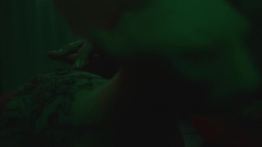 Close up view of a person touching a tattoo