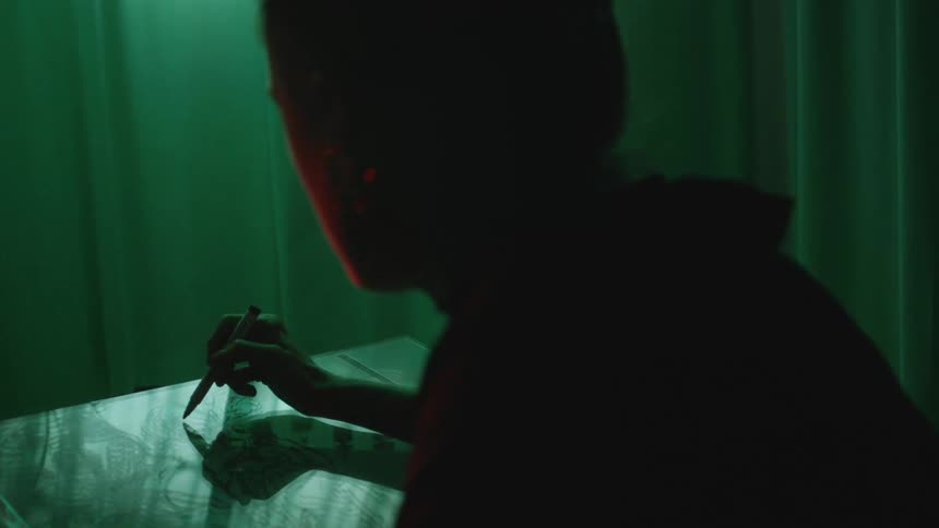 A woman is sketching with a marker
