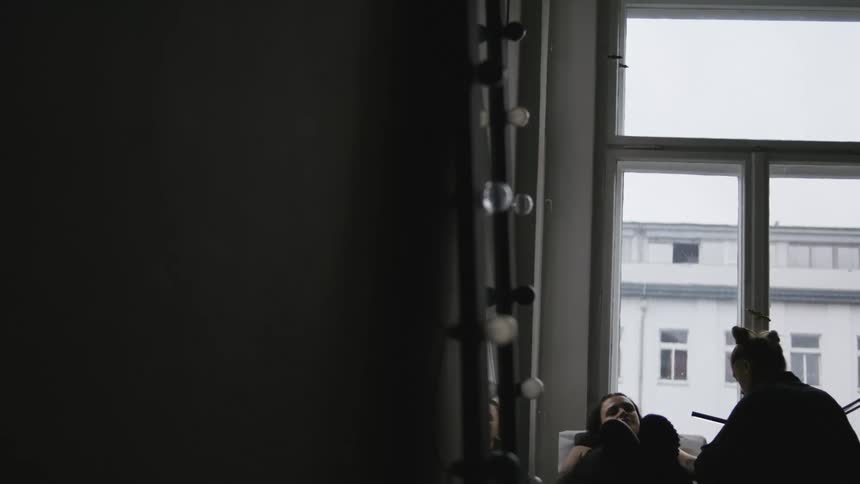 Two friends are hanging out inside of there home