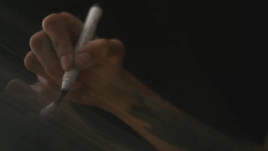 Close up view of a person drawing is displayed