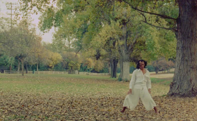 A man is dancing outside in the middle of the day time