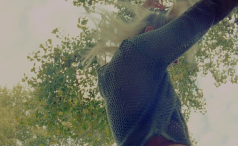 Young woman is dancing outdoors in the day time