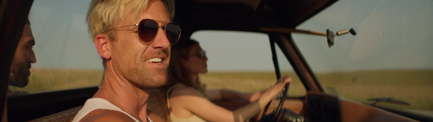A group of friends are driving through a rural area