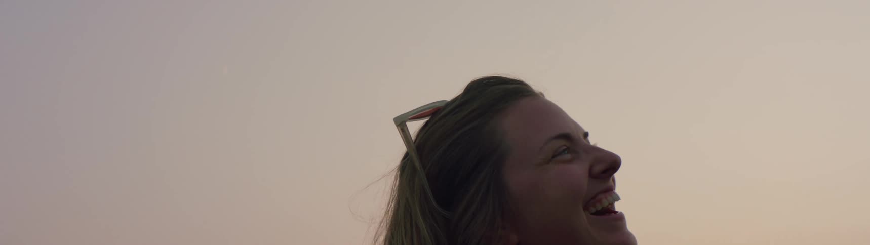 A woman is hiking outdoors while the sun is setting