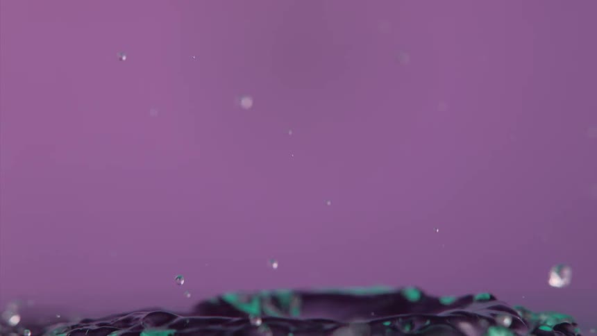 Liquid droplets are falling and splashing into each other