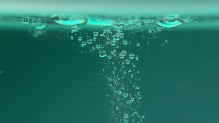 Slow motion view of a liquid beverage is displayed