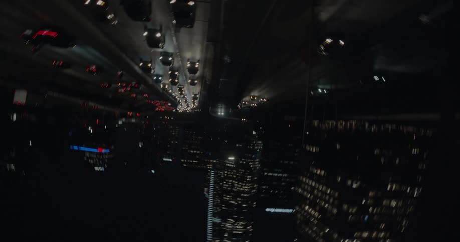 Cars driving in a city past high rise office buildings