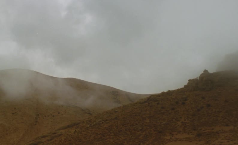 Low lying clouds cover tops of hills on overcast day