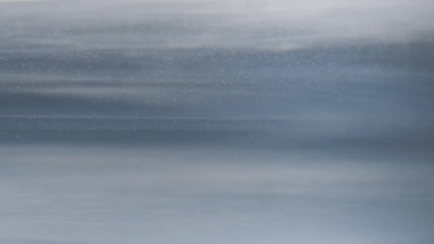Wind blows particles through sky over ice obscuring the area