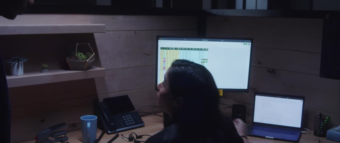 A man walks into his colleagues cubicle to chat