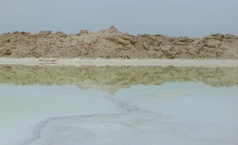 A canyon reflects off a lake below