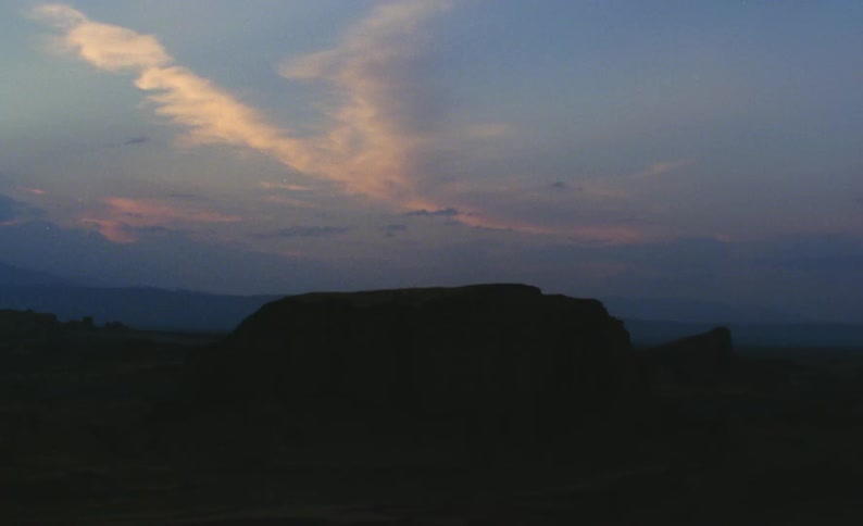 Clouds over a cliff as the sun sets