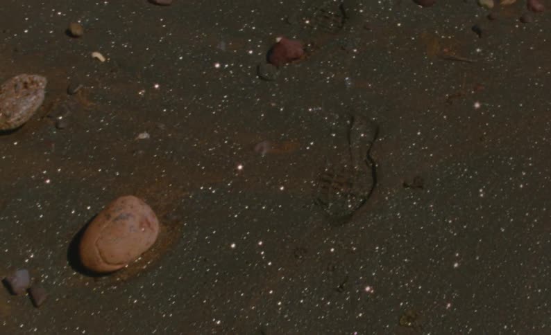 Close up of the ocean and beach is displayed