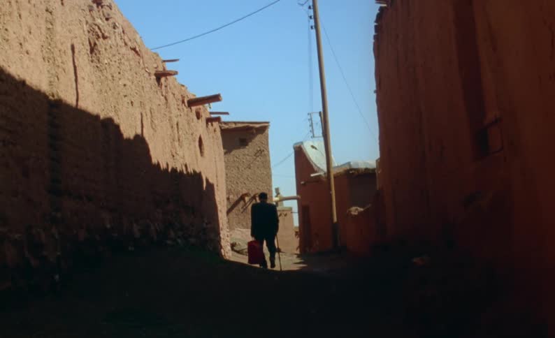 A man walking through an alley way